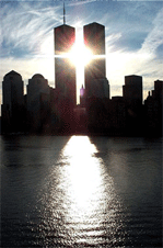 image of twin towers with sun peeking between.